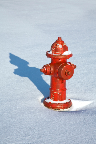 a red fire hydrant set against a fresh blanket of snow..