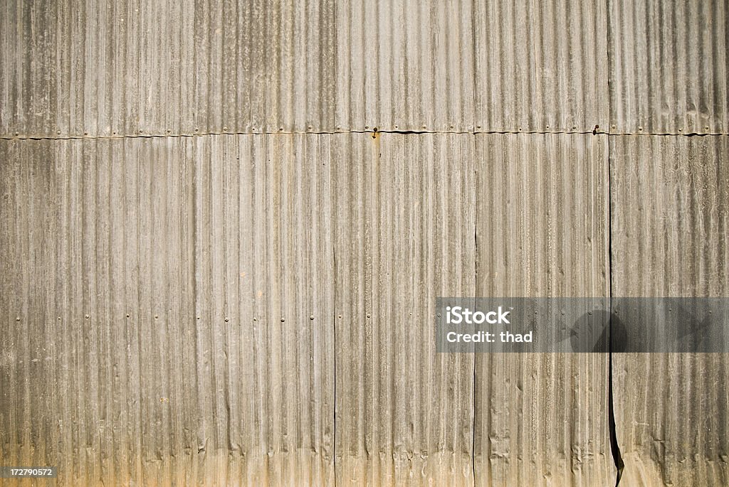 Corrugated Iron Wall A corrugated iron wall lit by the Australian sun. Architectural Feature Stock Photo