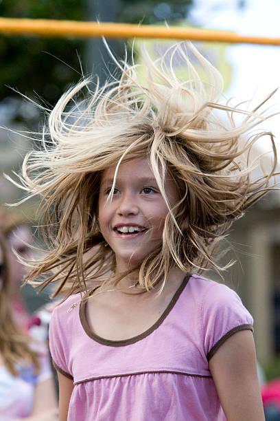 Young Girl Jumping Rope with Flying Hair stock photo