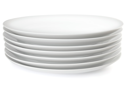 Stack of plain white dinner plates, on white background