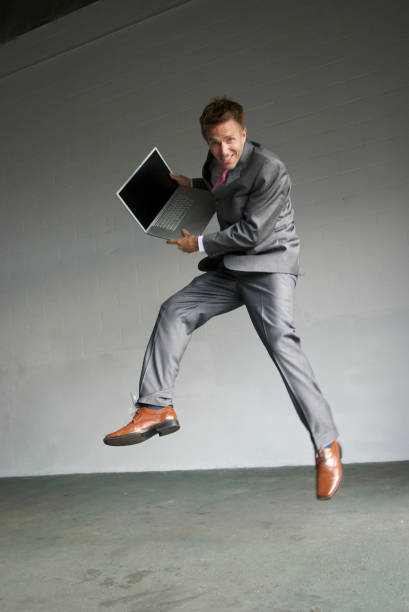 istock Businessman Jumping in Warehouse with Laptop 172791752