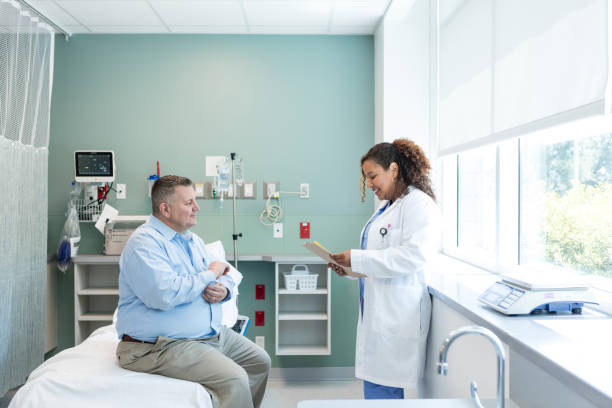 Female physician reads medical history while visiting her patient