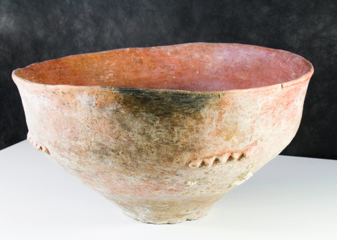 A pot from the Early Bronze Age made of terracotta and burnished inside. The nipple decoration is typical of that period. Partiallyblackened in the kiln.