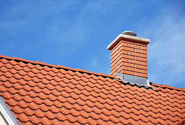 smoke stack and roof smoke stack on the tiled roof of a family house smoke stack stock pictures, royalty-free photos & images