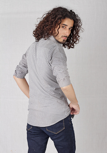Long curly hair man posing in style