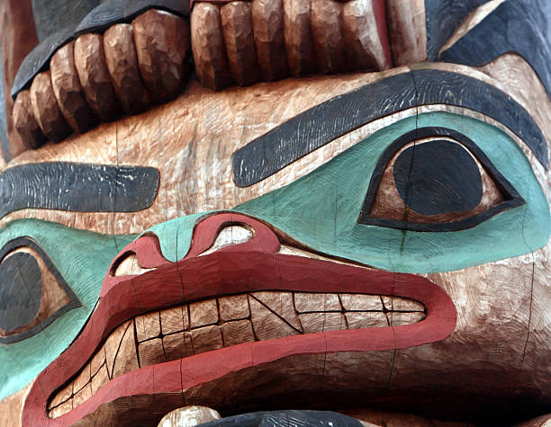 Totem Pole Close-up view of a totem pole. totem pole face stock pictures, royalty-free photos & images