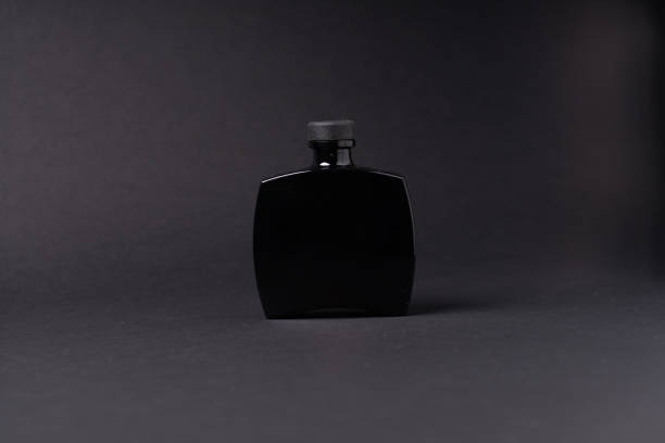 istock Horizontal mockup of dark glass bottle product container. 1727940554