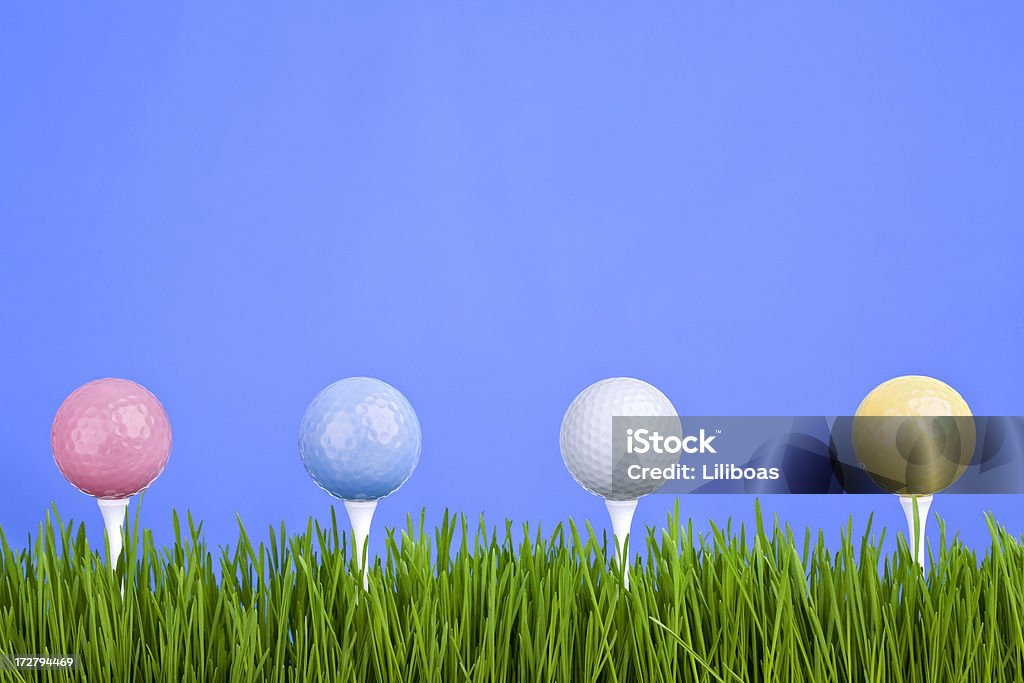 Golfing (XL) Different colored golf balls in the grass on blue.Some others you might also like: Blue Stock Photo