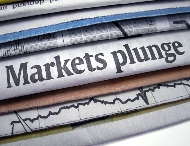 Newspapers stacked with Markets Plunge headline stock photo