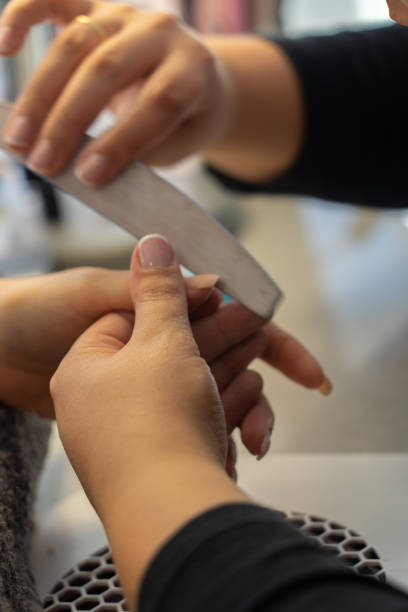 istock Woman's hand doing manicure filing nails 1727946598