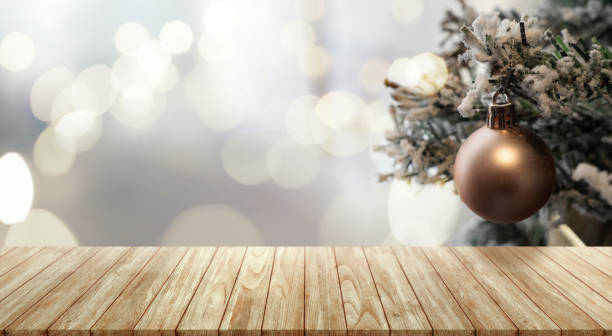istock Empty wooden table top with living room decor with christmas tree string light background. 1727947161