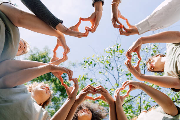 Volunteers making a heart shape with their hands