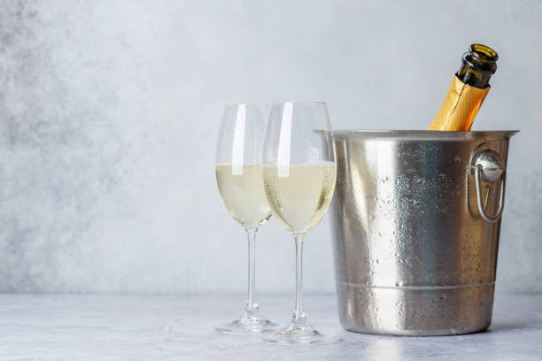 Two champagne glasses and bottle in ice bucket Two champagne glasses and bottle in ice bucket with copy space champagne-glass-shadow stock pictures, royalty-free photos & images