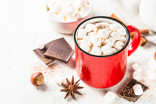 Hot chocolate with marshmallow in red mug.