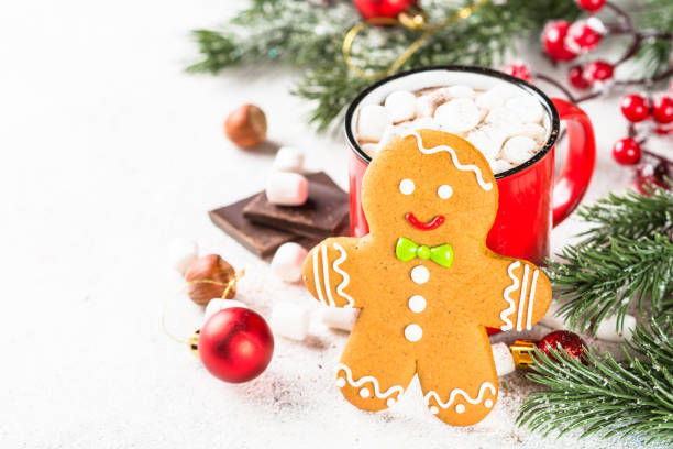 istock Hot chocolate with marshmallow and gingerbread man at white table. 1727953657