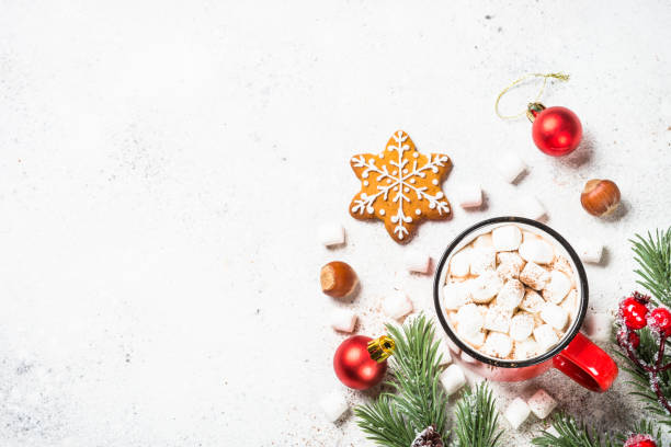 istock Hot chocolate with marshmallow and christmas cookies at white table. 1727953692