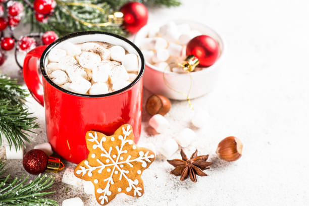 istock Hot chocolate with marshmallow and christmas cookies at white table. 1727954235