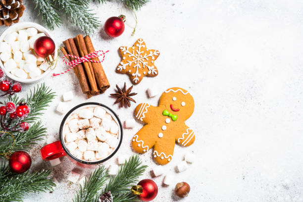 istock Hot chocolate with marshmallow and christmas cookies at white table. 1727954304