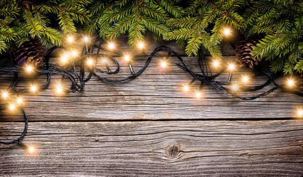 istock Christmas glowing garland and fir tree branches 1727957061