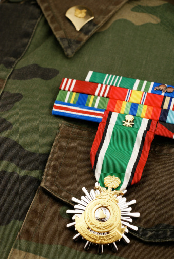 United States Army camouflage uniform with ribbon commendations and Liberation of Kuwait medal.