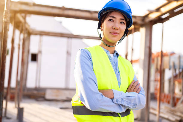 istock Portrait of a woman engineer, construction worker or an architect working at the construction site. 1727964195
