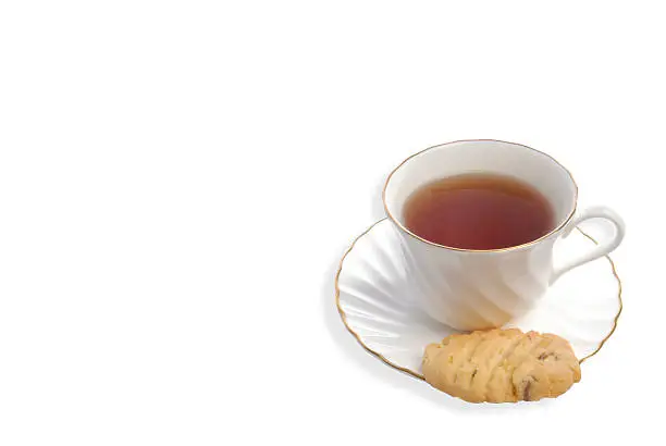 Photo of Cup of tea and chocolate chip cookie on white background