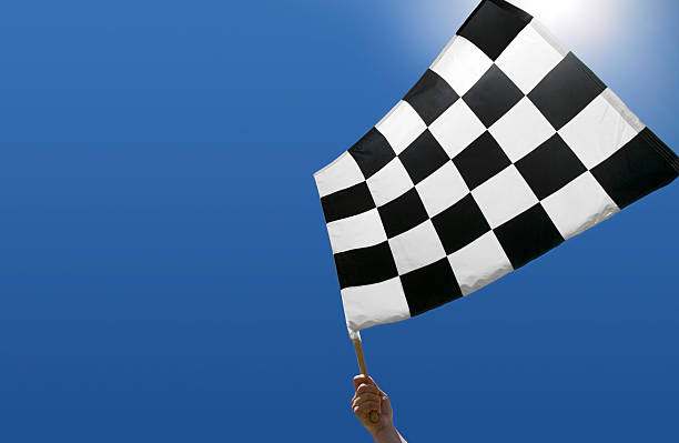 istock Checkered flag waving against blue sky 172797255