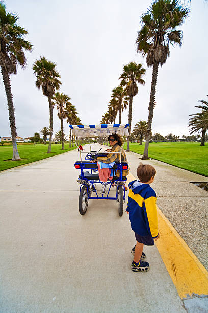 Bycycle Cart Mother and child riding cycling cart. mm1 stock pictures, royalty-free photos & images
