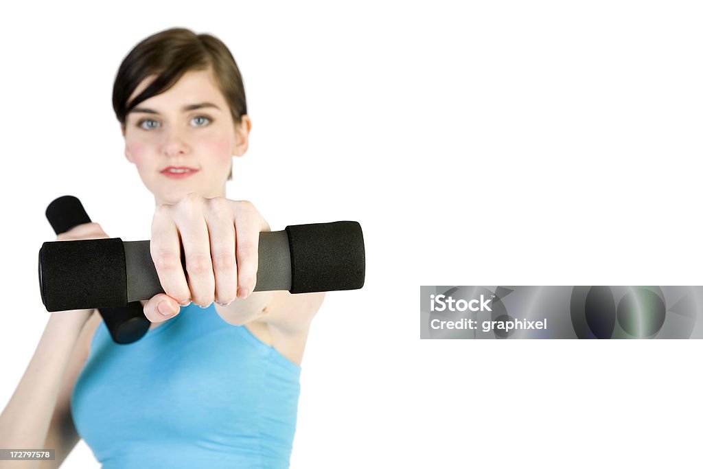 Portrait of a young woman exercising with dumbbells Adult Stock Photo