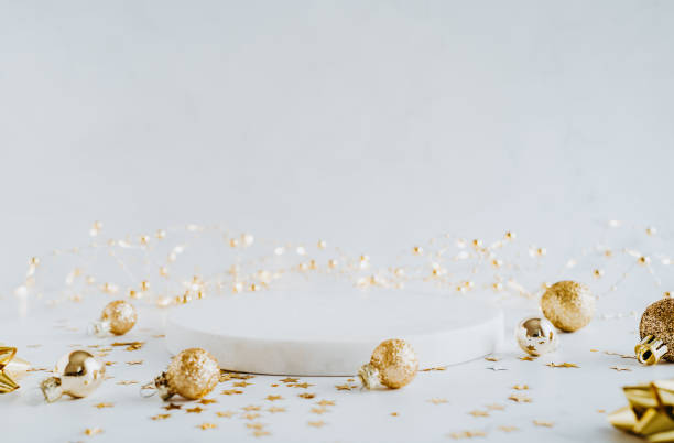White marble cosmetic podium product and Christmas golden decoration. stock photo