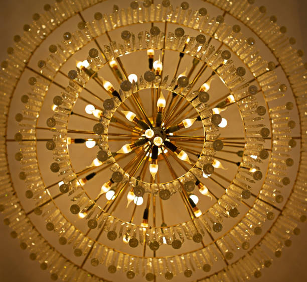 istock Crystal lamp giving a yellow glow to the ceiling. 1727979973