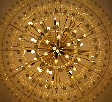 Crystal lamp giving a yellow glow to the ceiling.