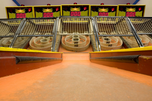 A row of skee ball machines at the arcade.