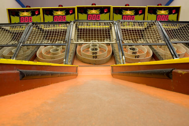 Skee Ball A row of skee ball machines at the arcade. midway fair stock pictures, royalty-free photos & images