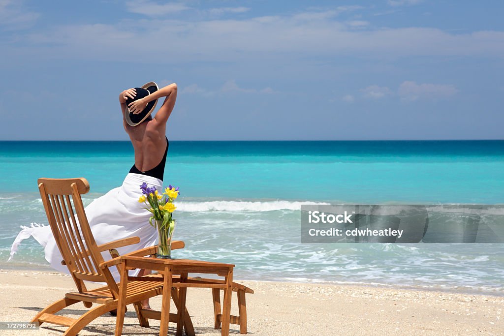ocean breeze woman enjoying a breezy day on a tropical beach Bouquet Stock Photo