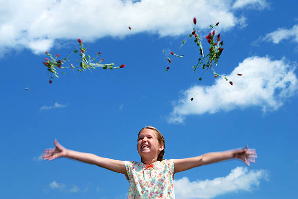 istock Young girl having fun throwing crimson clover into sky 172798837
