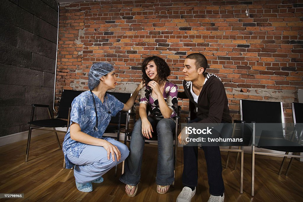 Doctor's day "A caring doctor is comforting a sad young couple. Concepts; healthcare; medical concepts, bad news." Adult Stock Photo