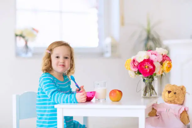 Photo of Baby eating vegetables. Solid food for infant.