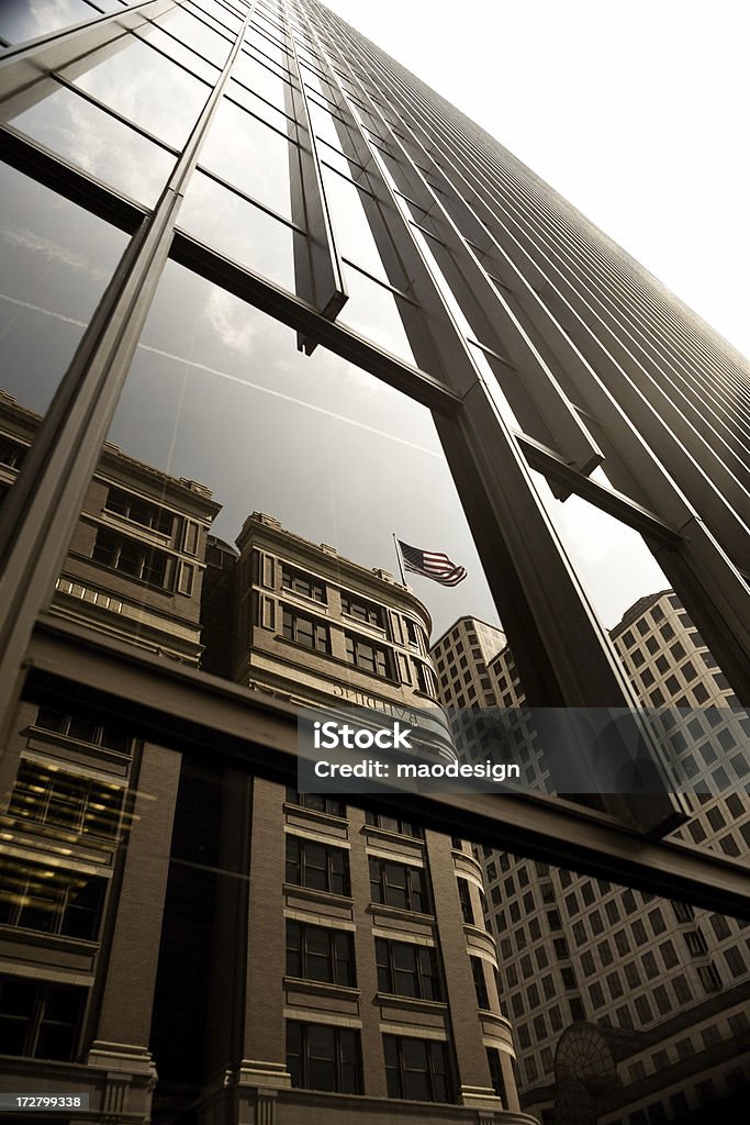 Office Buildings Office buildings and US flag reflection. American Flag Stock Photo