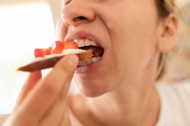 istock woman eating strawberry sandwich while dieting 1727993643