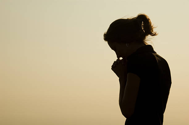 Prayer Silhouette A women praying.Similar Images: praying photos stock pictures, royalty-free photos & images