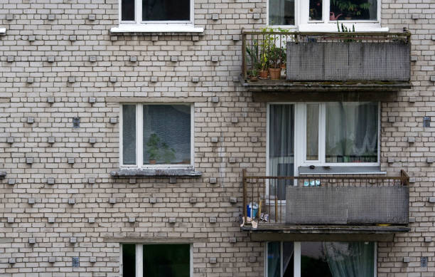 Greyish eastern bloc apartment house stock photo