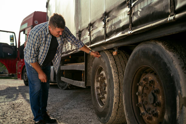 istock Truck driver checking tires before road 1727998829