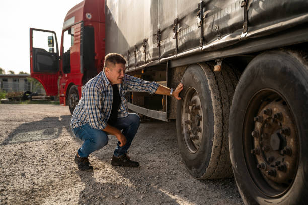 istock Truck driver checking tires before road 1727998845