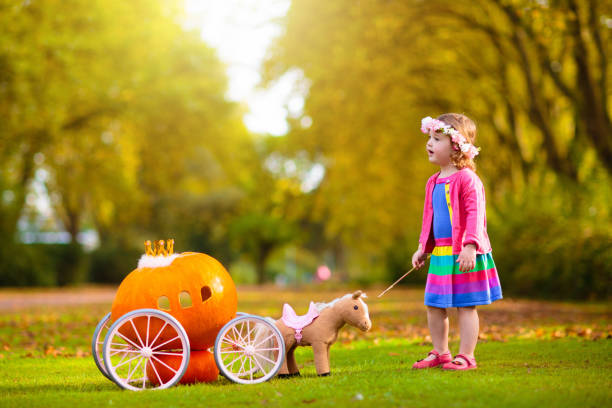 istock Little girl playing princess at pumpkin patch. 1727998922