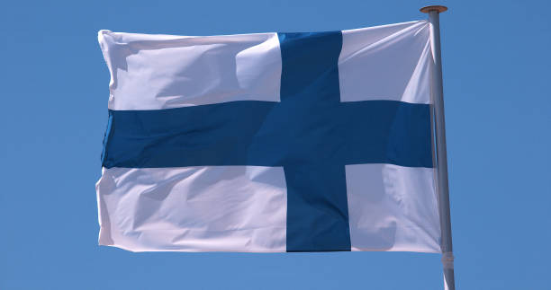 istock Finnish Flag Waving in the Wind against blue sky 1728004026