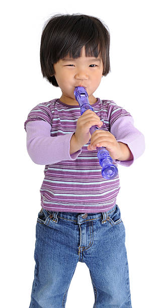 Preschooler Trying to Play Musical Instrument (Isolated on White) stock photo