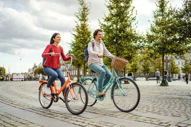 istock Romantic couple riding bicycles through the city 1728007812