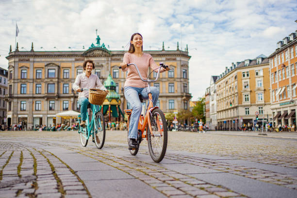 istock Romantic couple riding bicycles through the city 1728007902