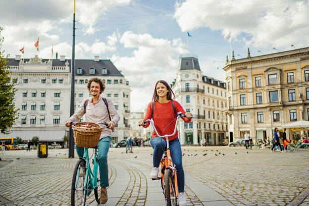 istock Romantic couple riding bicycles through the city 1728007945